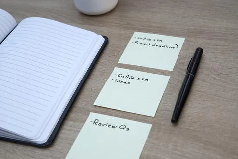 Sticky notes, pen and open notebook on desk Stock Photos