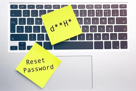 Sticky notes with phrase Reset Password and posscode on laptop, top view Stock Photos