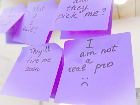 Sticky notes represent self-doubt and the emotional struggle of imposter synd Stock Photos