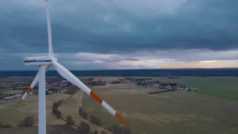 Still aerial shot of moving wind turbine Stock Footage 159673041