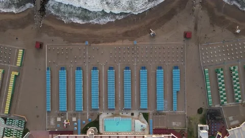 Still high aerial top down shot of blue beach resort. Tidy and beautiful back Stock Footage 152957806