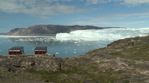 Still huts in front of EQI glacier panorama man stopping and looking Greenland Stock Footage 59999652