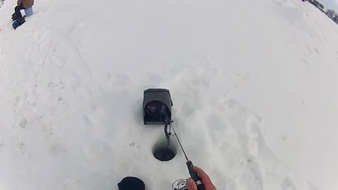 Still Ice Fishing Done By An Angler With Fish Finder Device On Site. POV Stock Footage