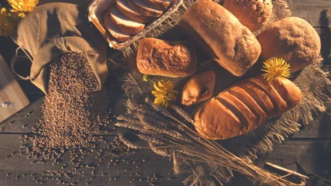 Still life with bread, wheat, flour and flowers. Stock Footage 89139649