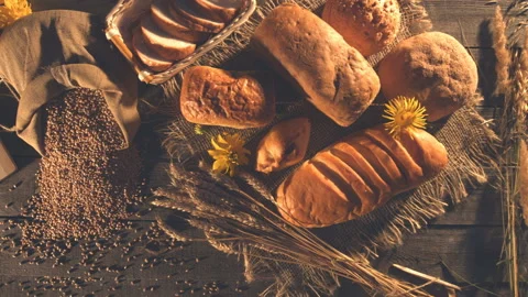 Still life with bread, wheat, flour and flowers. Stock Footage 89140057