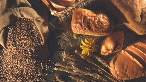 Still life with bread, wheat, flour and flowers. Stock Footage 89140240