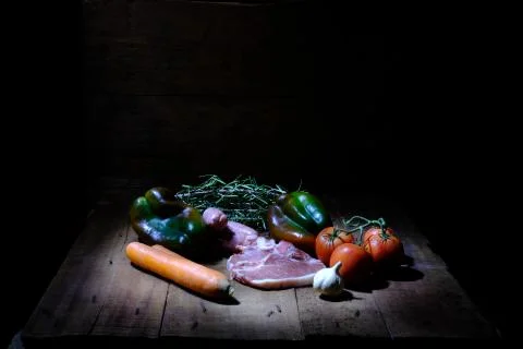 Still life with Caravaggesque style food.  fish, vegetables and meat Stock Photos