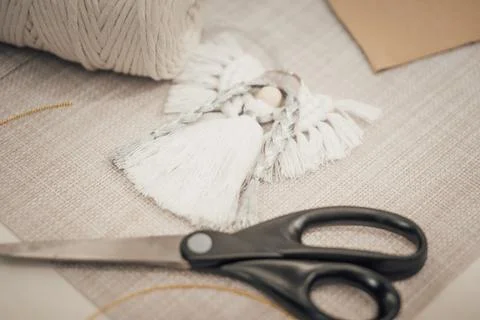 Still life composition of macrame tools with scissors and cotton cord, suit.. Stock Photos