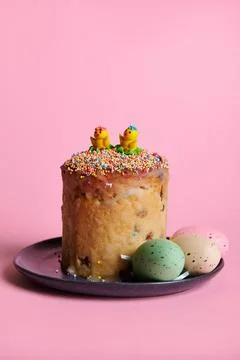 Still life with Easter cake and colorful eggs on navy ceramic plate, isolated Stock Photos