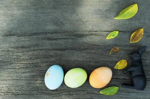 Still life with easter eggs and atum leaves on wooden backgrounds above Stock Photos