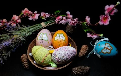 Still life of Easter eggs in a wooden bowl on various backgrounds Stock Photos