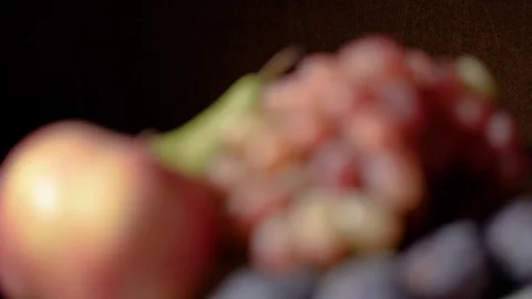 Still life with fruit and red wine. Grapes, apples, pear, plums, nuts and blue d Видео 119105677