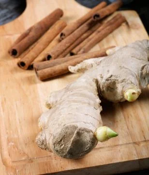 Still-life with ginger and cinnamon on an old kitchen table Stock Photos