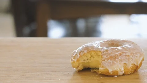 Still Life of a Glazed Donut With a Bite In It Stock Footage 106091872