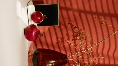 Still life with grapefruit, mirror cube, vase with dried flowers, red cloth with Stock Footage 197816705