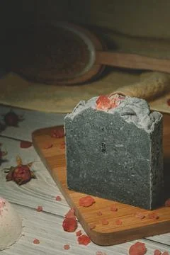 Still life of a handmade soap stack on a wooden board. Focus on the soap stack Stock Photos