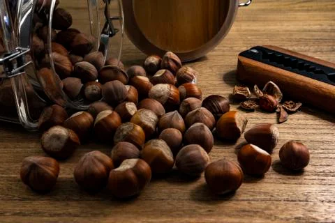 A still life of hazelnuts with a nutcracker Stock Photos