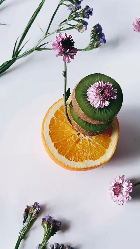 Still life, looking down, scene, kiwi, oranges, flowers, arrangement, Stock Footage 267270532