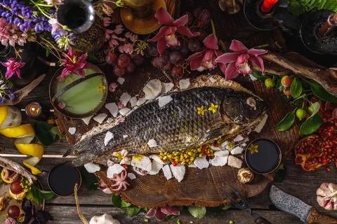 Still life in old masters style with fish, glass of wine, old dishes, fruits. Stock Photos