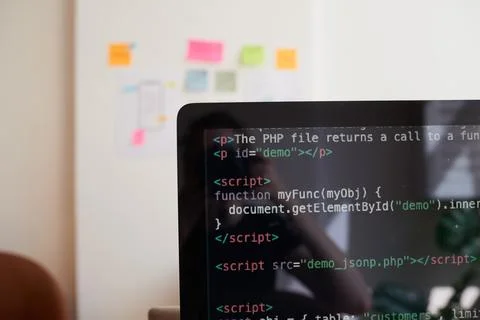 Still life of PC screen with javascript coding demo, on desk in office 库存照片