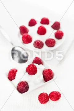 Still life with raspberry sour cream dessert on white linen table cloth, copy Stock Photos