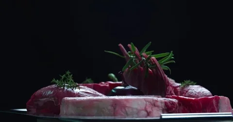 Still life raw meat composition rotation 4k looped video on black background Stock Footage 70197509