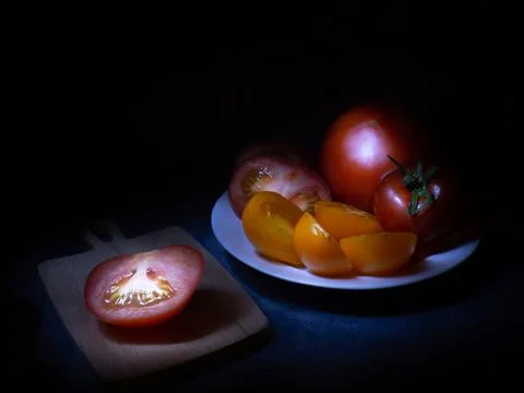 Still life in the rays of light. Tomatoes. Vegetables on the table. Ingredients  Stock Photos