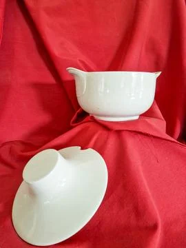 Still life on a red background from a ceramic casserole Stock Photos