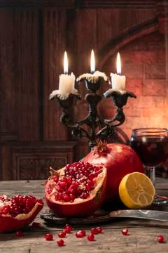 Still life in a rustic style. Fruit-pomegranates, lemon lying on a wooden tab Stock Photos