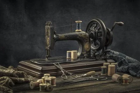 Still life with a sewing machine, scissors, threads Stock Photos