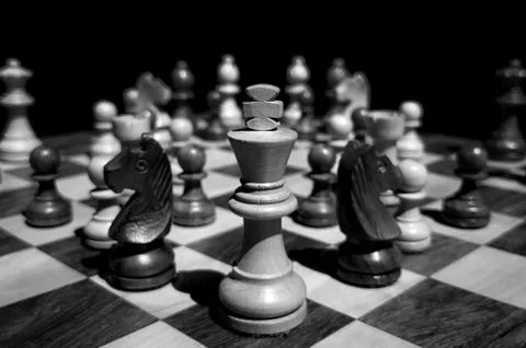 Still life shot of chess pieces on wooden board with blurred background Stock Photos