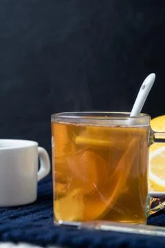 Still life of tea with lemon, tablets and thermometer, jam and berries. The c Stock Photos