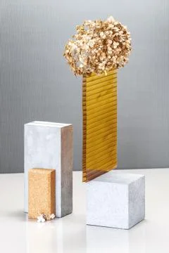 Still life using concrete blocks, textural building elements and a golden pla Stock Photos