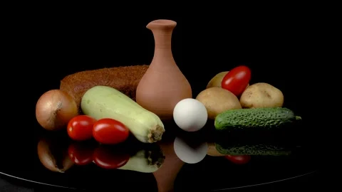 Still life with vegetables and bread on a black background. Stock Footage 159469805