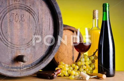 Still life with wine, grapes and barrels Stock Photos