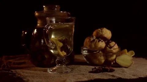 Still life.There are a cup of tea, a tea pot and a plate with eclairs on the Stock Footage 82296386