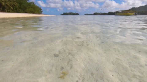 Still low angle view of calm lagoon water surface ripple at a shallow beach side Stock Footage 250400440