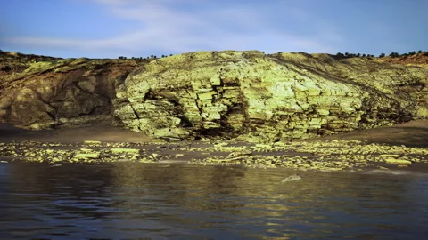Still ocean surface creates near perfect symmetry of sky and sunlit cliffs Stock Footage 341564135