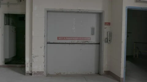 A still shot of a closed freight elevator in an abandoned factory. Stock Footage 65504595