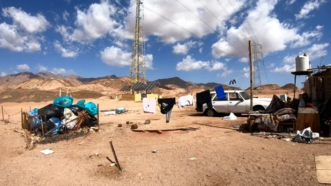 Still shot of garbage waste, broken car and hanging washed clothes in the Stock Footage 106755316