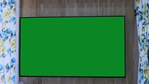 Still shot of a large television fixed on a wooden wall, green chroma key on tv Stock Footage 147646476