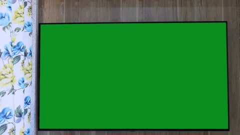 Still shot of a large television fixed on a wooden wall, green chroma key on tv Stock Footage 147646840