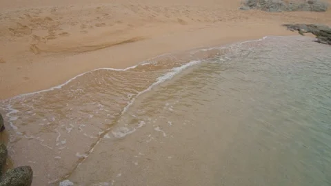Still shot of small wave spreading on the beach in slow motion, in Spain Stock Footage 230096480