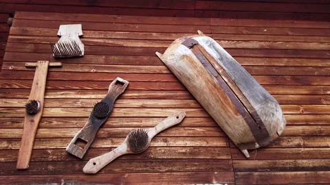 Still video of antique tools hanged on wooden wall background Stock Footage 345506288