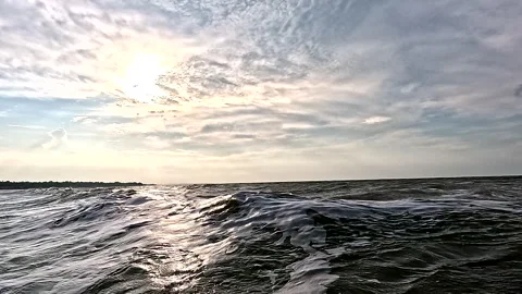 Still video of a calm ocean with small waves before sunset Видео 336910722