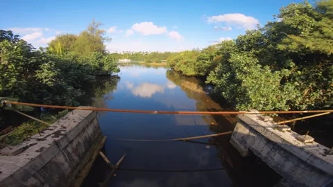 Still view from a bridge look out to small canal to turquoise blue lagoon with g Stock Footage 253459396