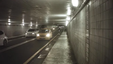 Still view of incoming traffic inside a old dirty tunnel with strong bright head Stock-Footage 237251804