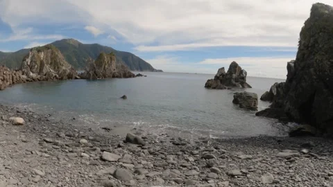 Still view look out to pacific ocean horizon from rocky seashore coastline with  Stock Footage 263017246