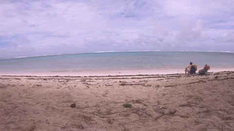 Still view at sandy beach with calm peaceful lagoon with a couple man and woman  Video stock 244115818
