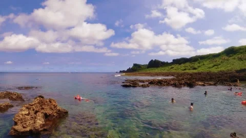 Still view of a small shallow bay area where kids and family are having fun snor Stock Footage 279143159